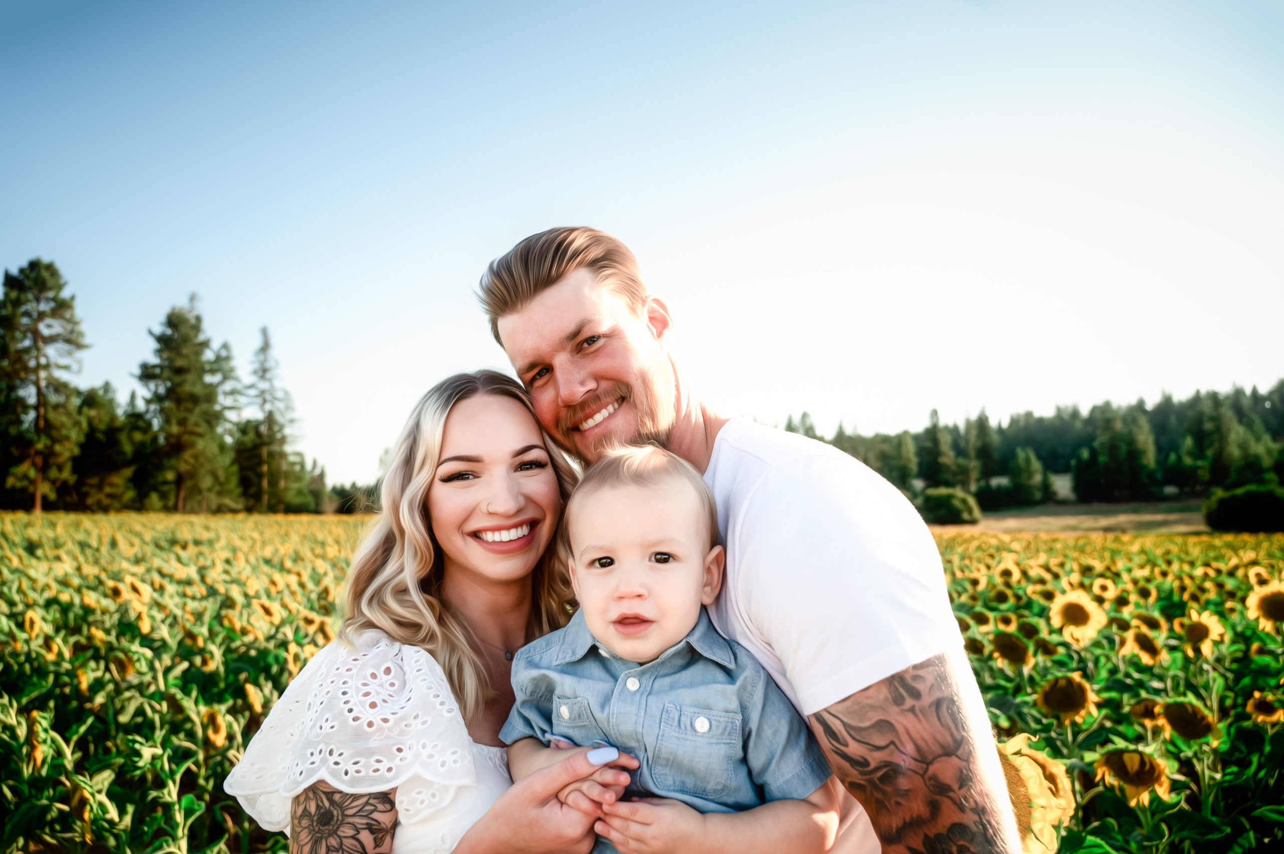 family of three snuggling in a field of flowers at Half Moon Blooms