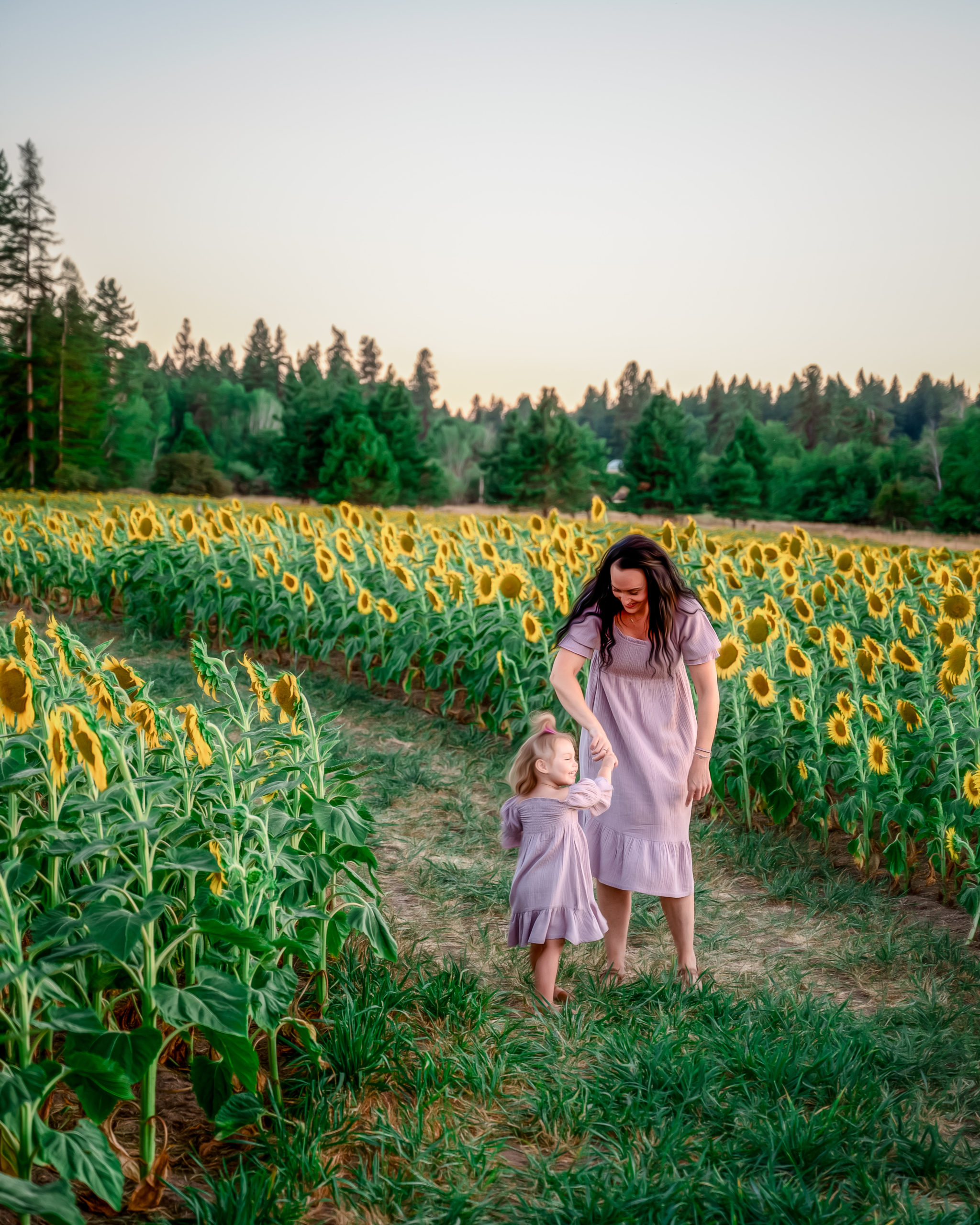 mom and daughter playing in a sunflower field Spokane Obstetrics and Gynecology