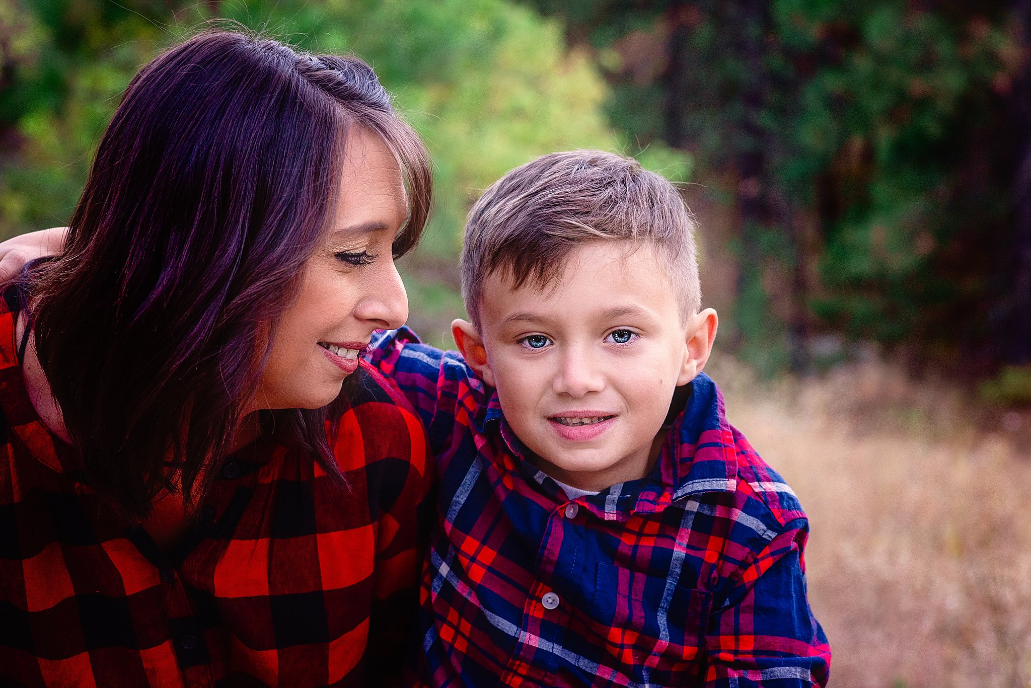 mom looking at her young son in a red plaid shirt Spokane Pediatricians