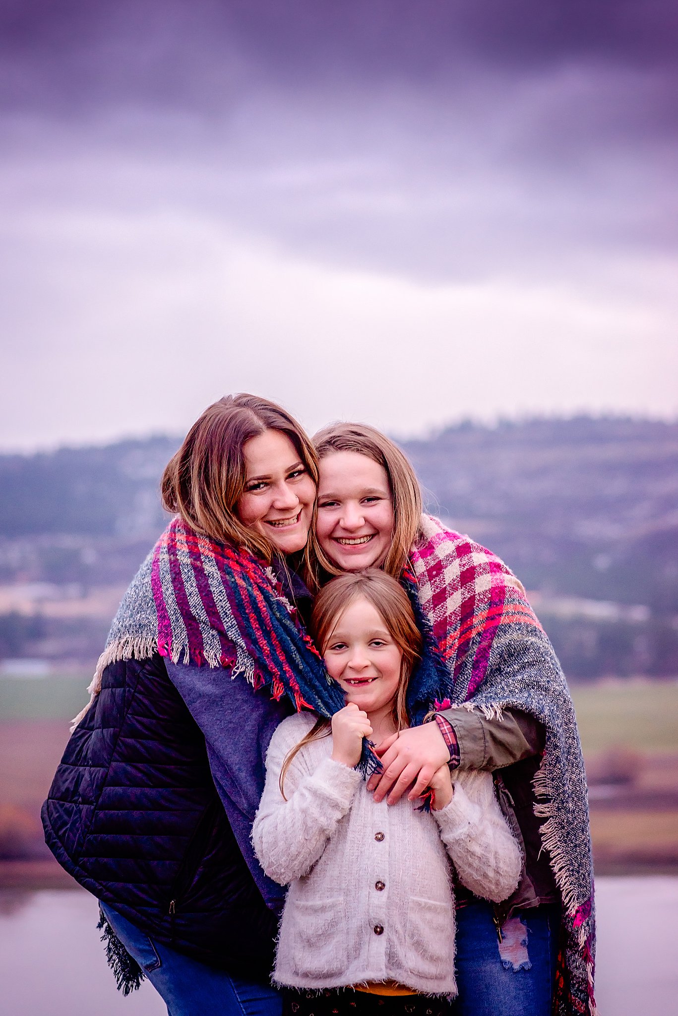 Mom hugging her daughters on the mountainside Northwest OBGYN Spokane